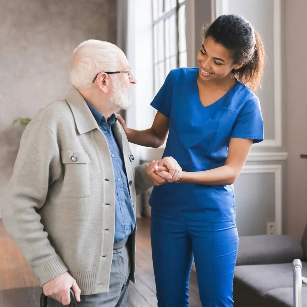 COHME home health aide assisting an elderly woman at home in New York City
