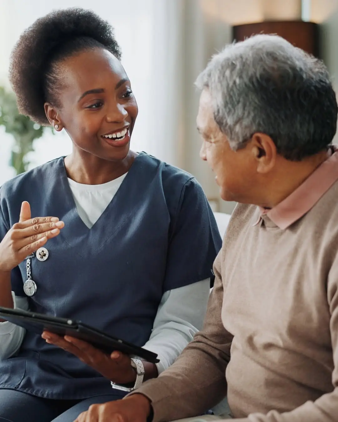COHME caregiver laughing together with an elderly client